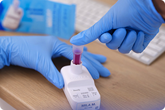 Placing test vial into the LUCIRA® by Pfizer COVID-19 & Flu Test device