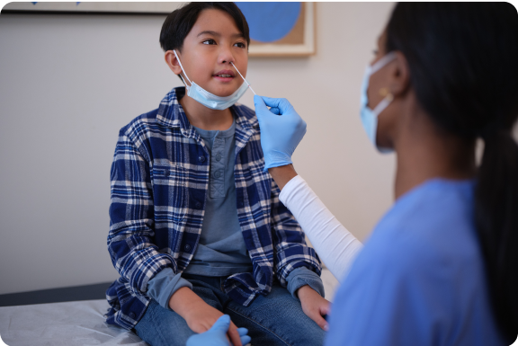 Actor portrayal of nurse swabbing child's nose